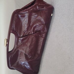 Elliott Lucca patent leather clutch in burgandy